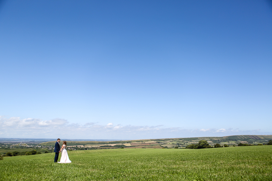 Bride and groom in Green lush field