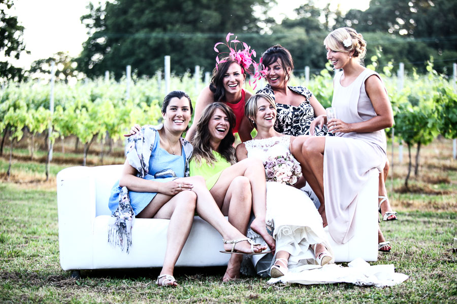 Bride with Friends on Soafa outside at the Englsh Oak Vineyard
