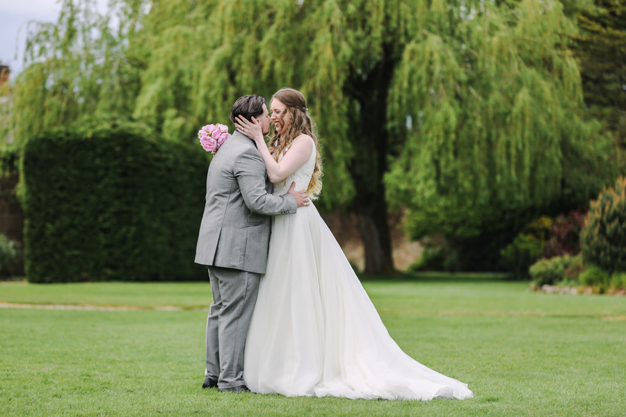 Bride and groom by Tree