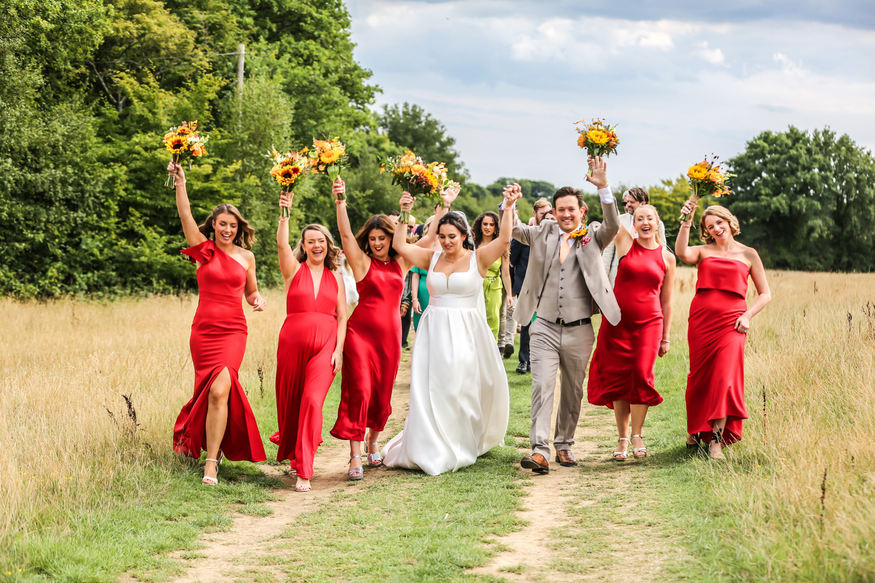 Natural wedding photography in Bournemouth with bride and groom celebrating with their wedding party outdoors